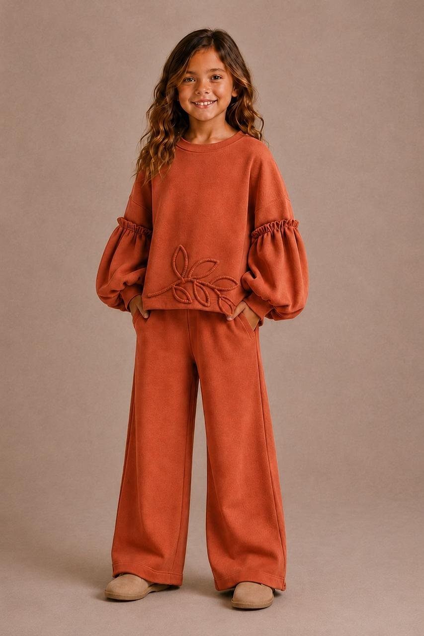Girl wearing a rust Coucou Maman lounge set